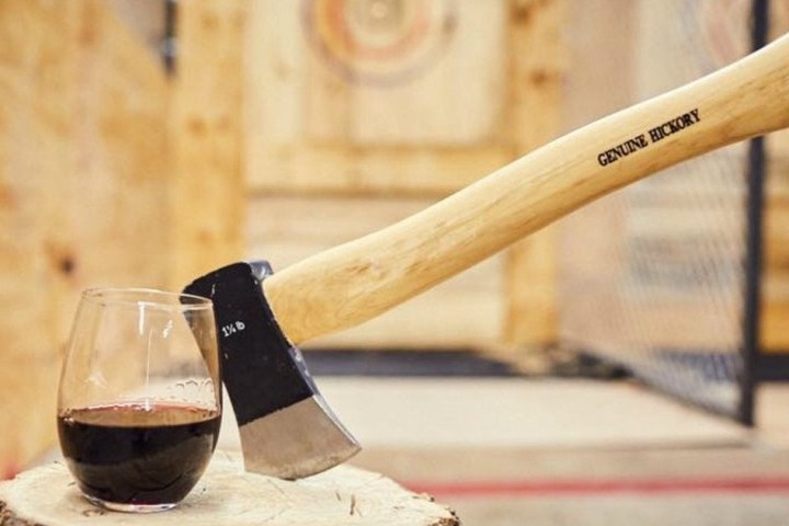 a glass of wine sitting on top of a wooden table